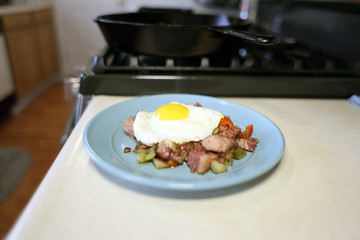 Plate of corned beef hash with a fried egg sunny side up.