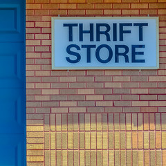 Obraz premium Square frame Building with pitched roof and large blue door viewed on a sunny day