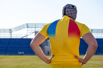 big powerful rugby player on the background of the stadium