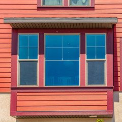 Fototapeta premium Square frame Window of a home with combination of wood section and neutral exterior wall