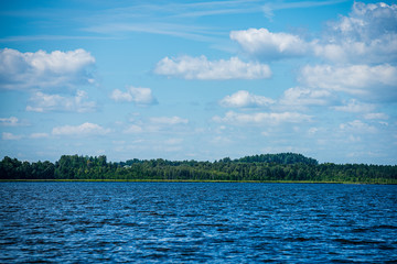 blue sky with white clouds over countryside landscape