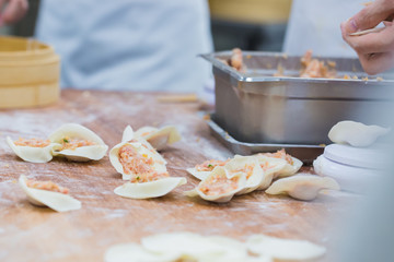 Dim Sum chefs working wrapping dumplings at famous restaurant in Taiwan.