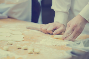 Dim Sum chefs working wrapping dumplings at famous restaurant in Taiwan.