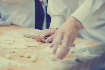 Dim Sum chefs working wrapping dumplings at famous restaurant in Taiwan.