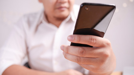 Businessman Holding and Using Smart Phone