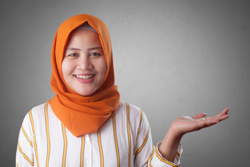 Muslim Lady Presenting Something on Her Side with Copy Space