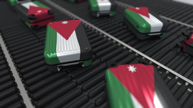 Many travel suitcases featuring flag of Jordan on roller conveyer. Jordanian tourism conceptual animation