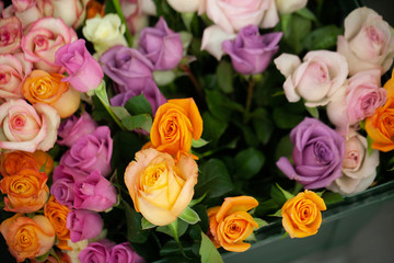Fototapeta premium Close up view of beautiful flowers mix in the box. Unpacking and deliver roses. Small business. Floral carpet for Wallpaper.