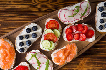Variation of toast with fruit , vegetable and salmon