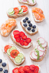Variation of toast with fruit , vegetable and salmon