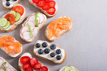 Variation of toast with fruit , vegetable and salmon