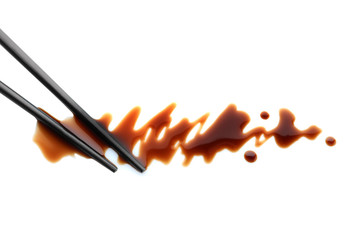 Delicious soy sauce and chopsticks isolated on white, top view