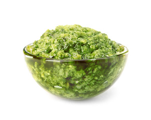 Bowl of tasty pesto sauce isolated on white