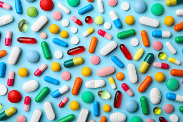 Different pills on color background, flat lay