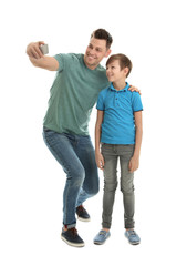 Dad and his son taking selfie on white background