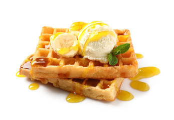 Delicious waffles with ice cream, banana and syrup on white background