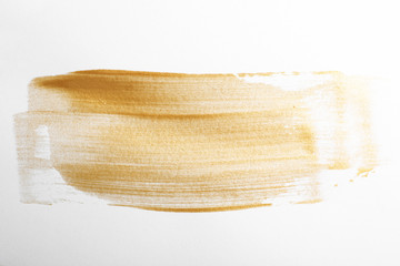Strokes of gold paint isolated on white, top view