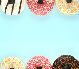 Delicious donuts on colorful background.