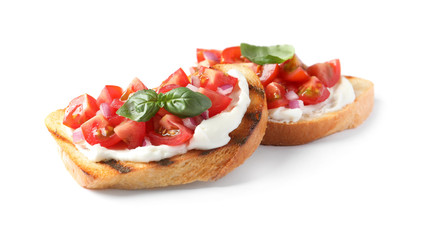 Tasty bruschettas with tomatoes on white background