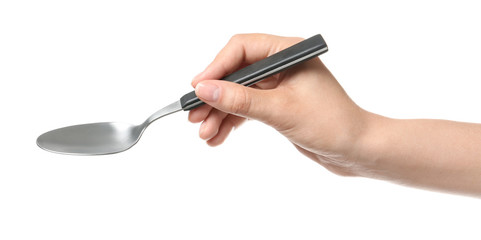 Woman holding clean tablespoon on white background, closeup