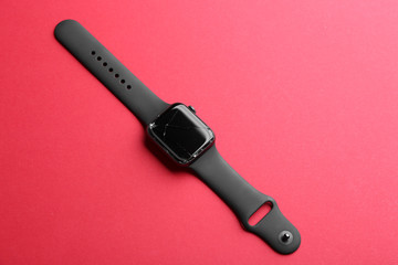 Broken smart watch on color background. Repair service