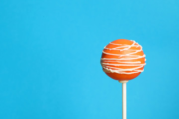 Bright delicious cake pop on color background. Space for text