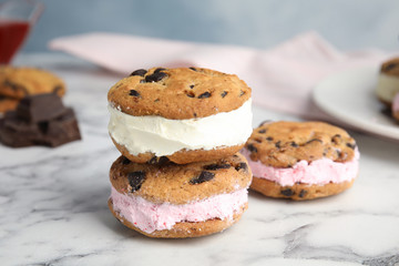 Sweet delicious ice cream cookie sandwiches on table