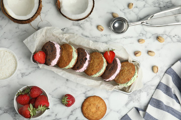 Different sweet delicious ice cream cookie sandwiches served on table, flat lay