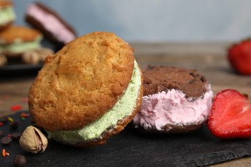 Sweet delicious ice cream cookie sandwiches on table, closeup