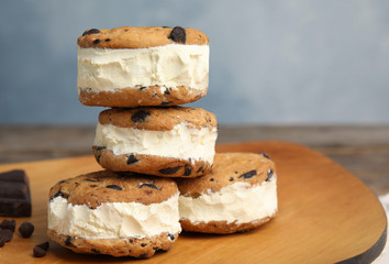 Sweet delicious ice cream cookie sandwiches on table, space for text