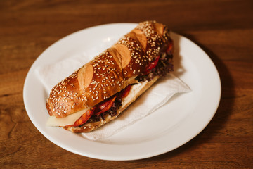 Sandwich with a kulen and a vegetable in a restaurant