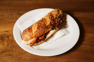Sandwich with a kulen and a vegetable in a restaurant
