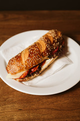 Sandwich with a kulen and a vegetable in a restaurant