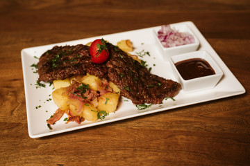 Steak with vegetables, potato and sauce  in the restaurant