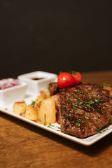 Steak with vegetables, potato and sauce  in the restaurant