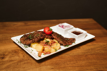 Steak with vegetables, potato and sauce  in the restaurant