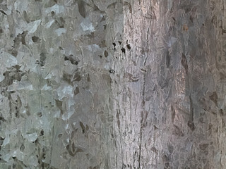 metal sheet with spots of dark and light gray
