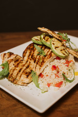 Grilled chicken with rice and vegetables by the glass of juice