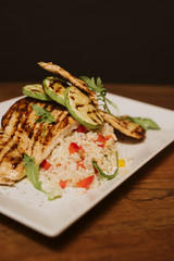 Grilled chicken with rice and vegetables by the glass of juice
