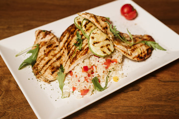 Grilled chicken with rice and vegetables by the glass of juice