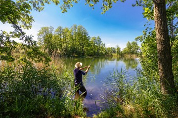 Fototapeta na wymiar angler catching the fish during summer day