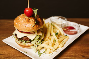 Hamburger with French fries and sauce in a restaurant