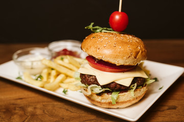 Hamburger with French fries and sauce in a restaurant