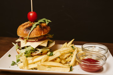 Hamburger with French fries and sauce in a restaurant