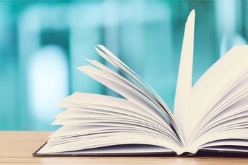 Stack of colorful books on blurred background