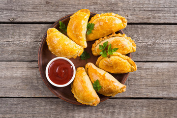 Latin American baked beef empanadas with sauce