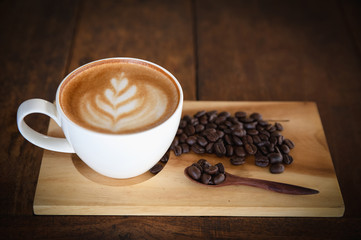coffee cup and coffee beans on old wooden background, Top view