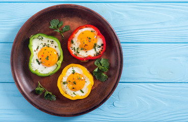 Yellow , red and green pepper with fried eggs