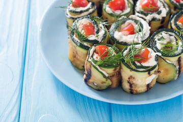 Zucchini rolls with cream cheese , tomatoes and dill