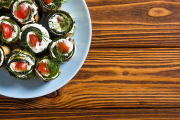 Zucchini rolls with cream cheese , tomatoes and dill